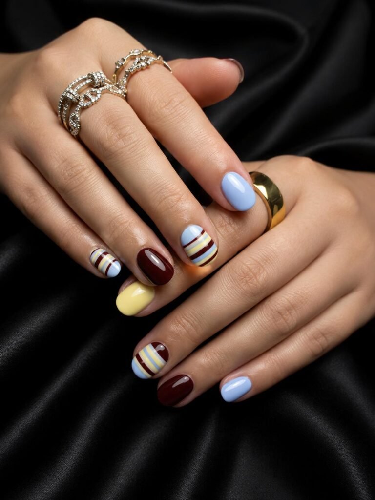 Gallery 23 Creative mixed nail design with blue black yellow and stripe details at Darya’s Touch Manchester