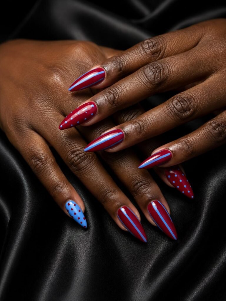 Gallery 21 Red and blue stiletto nails with glitter and artistic nail details at Darya’s Touch Manchester