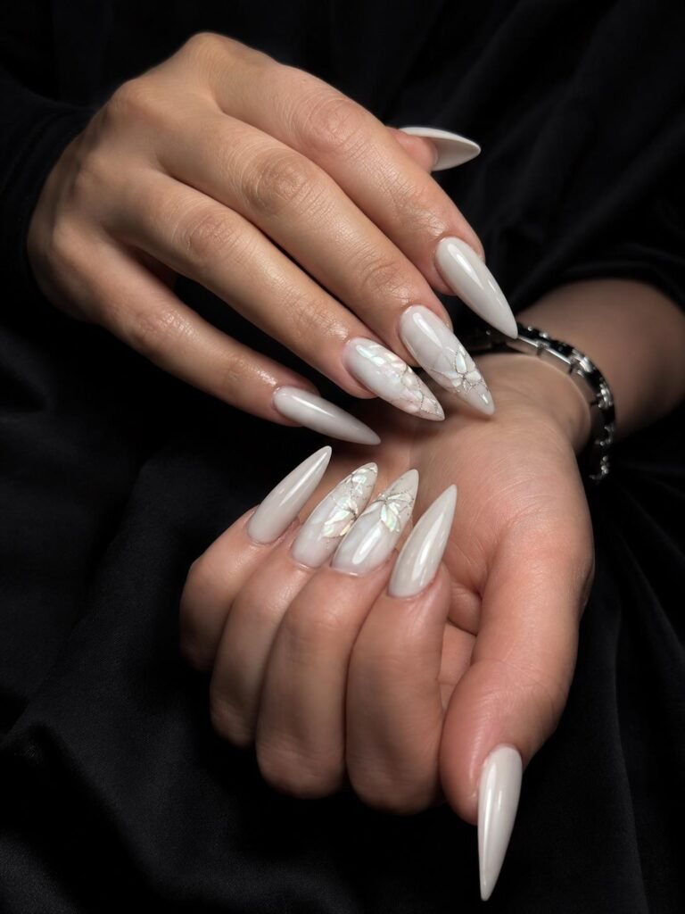 Gallery 19 White chrome stiletto nails with glossy finish at Darya’s Touch Manchester